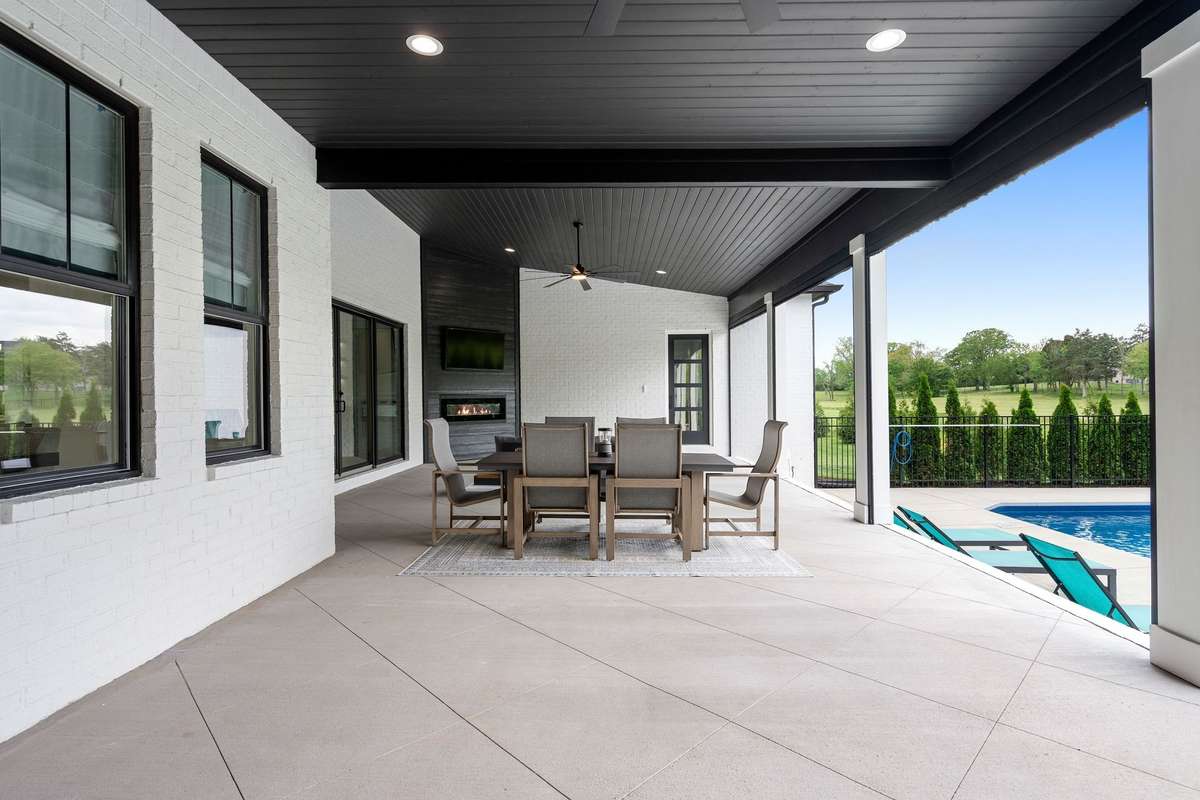 Covered patio with fireplace extending your living space outdoors in every season.
