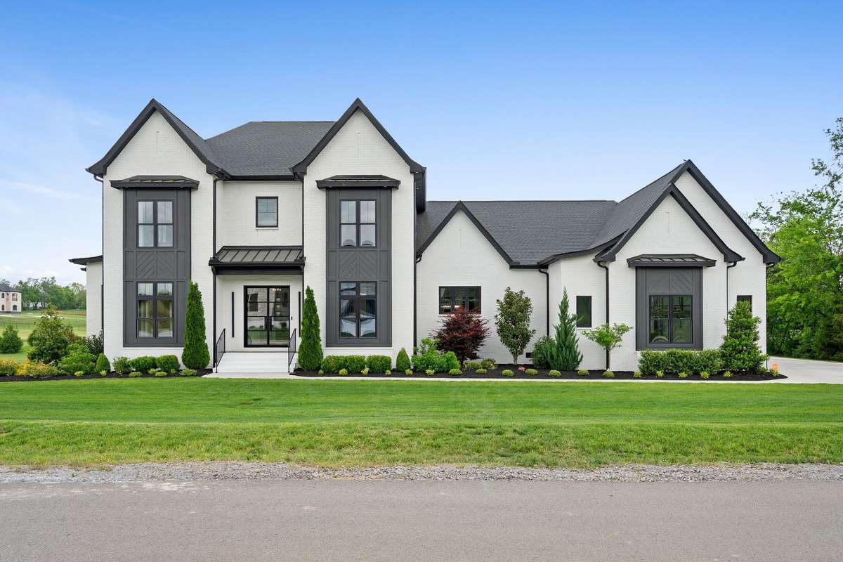 Stunning contemporary exterior with white brick, bold accents, and professionally landscaped 0.78-acre lot with irrigation system.