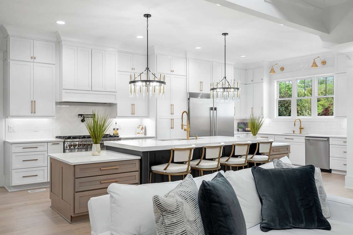 Luxury kitchen showcasing premium appliances including a 66” refrigerator, 48” gas range, and seamless open-concept design.