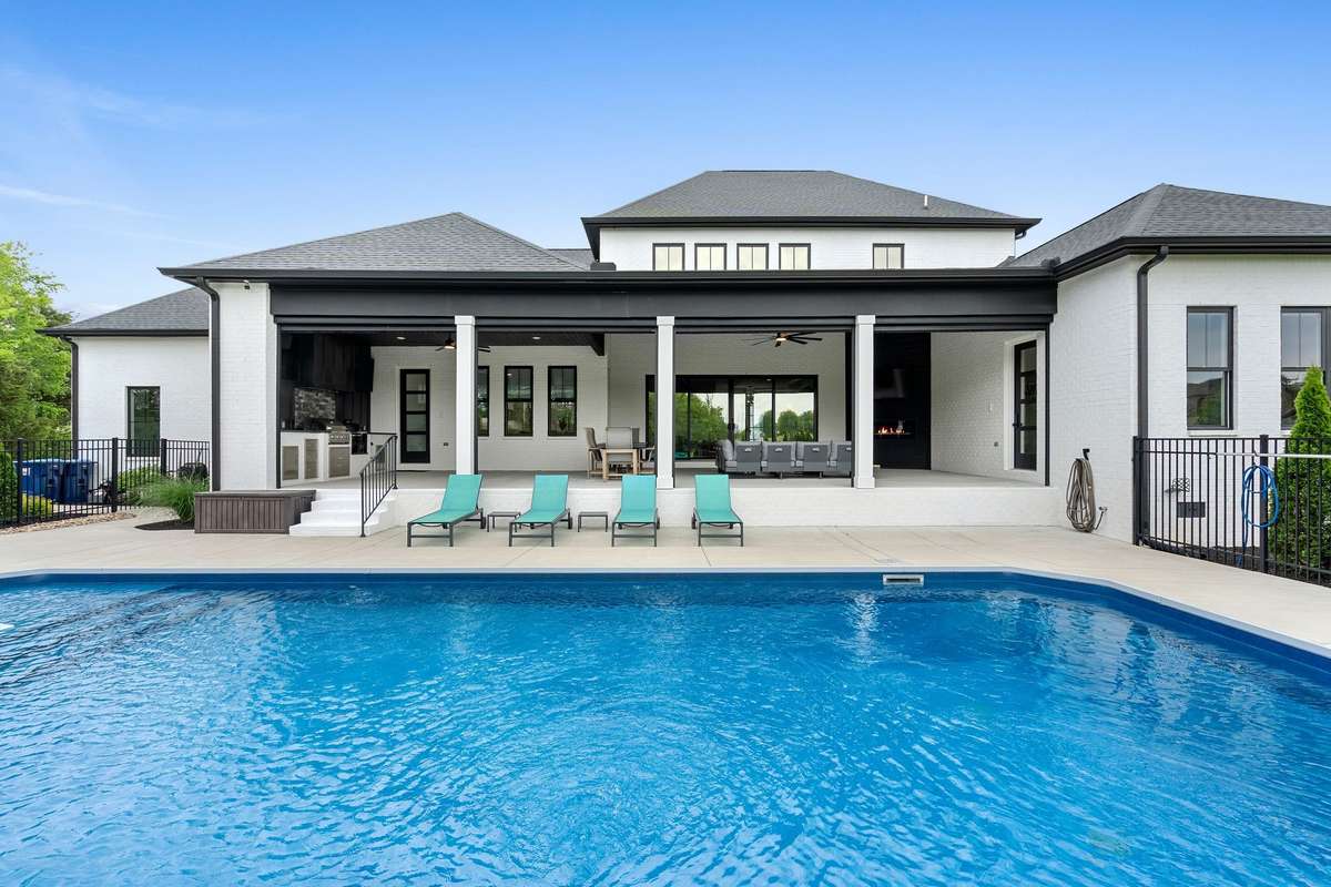 Exceptional covered entertaining space with motorized screens, outdoor kitchen, and fireplace—designed for year-round enjoyment.