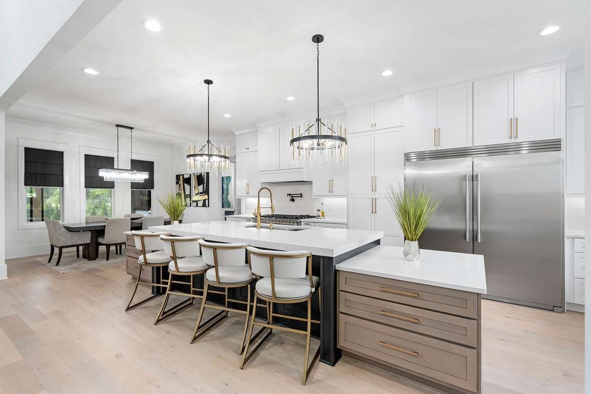 Stunning designer kitchen featuring a massive 15’ island, custom cabinetry, quartz countertops, and statement lighting—perfect for entertaining.