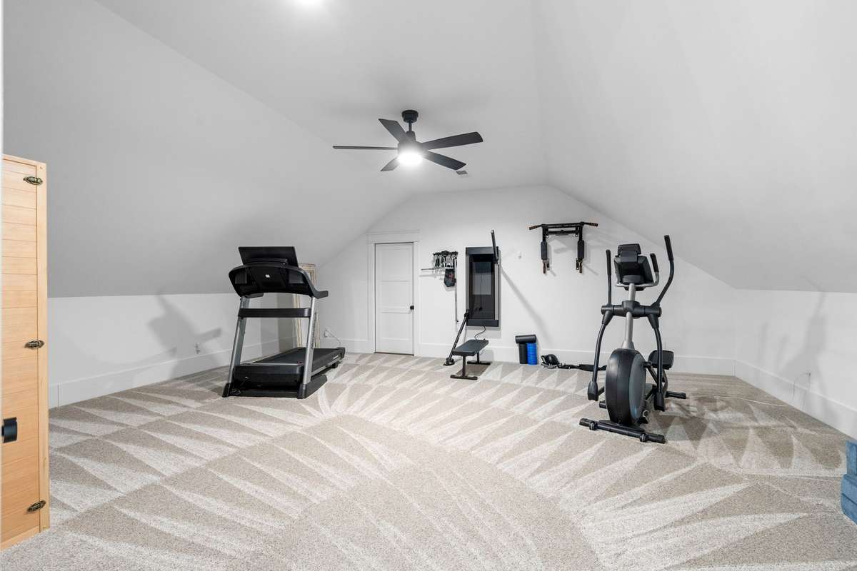 Expansive upper-level bonus room with vaulted ceilings—ideal for a home gym, media space, or flexible living.