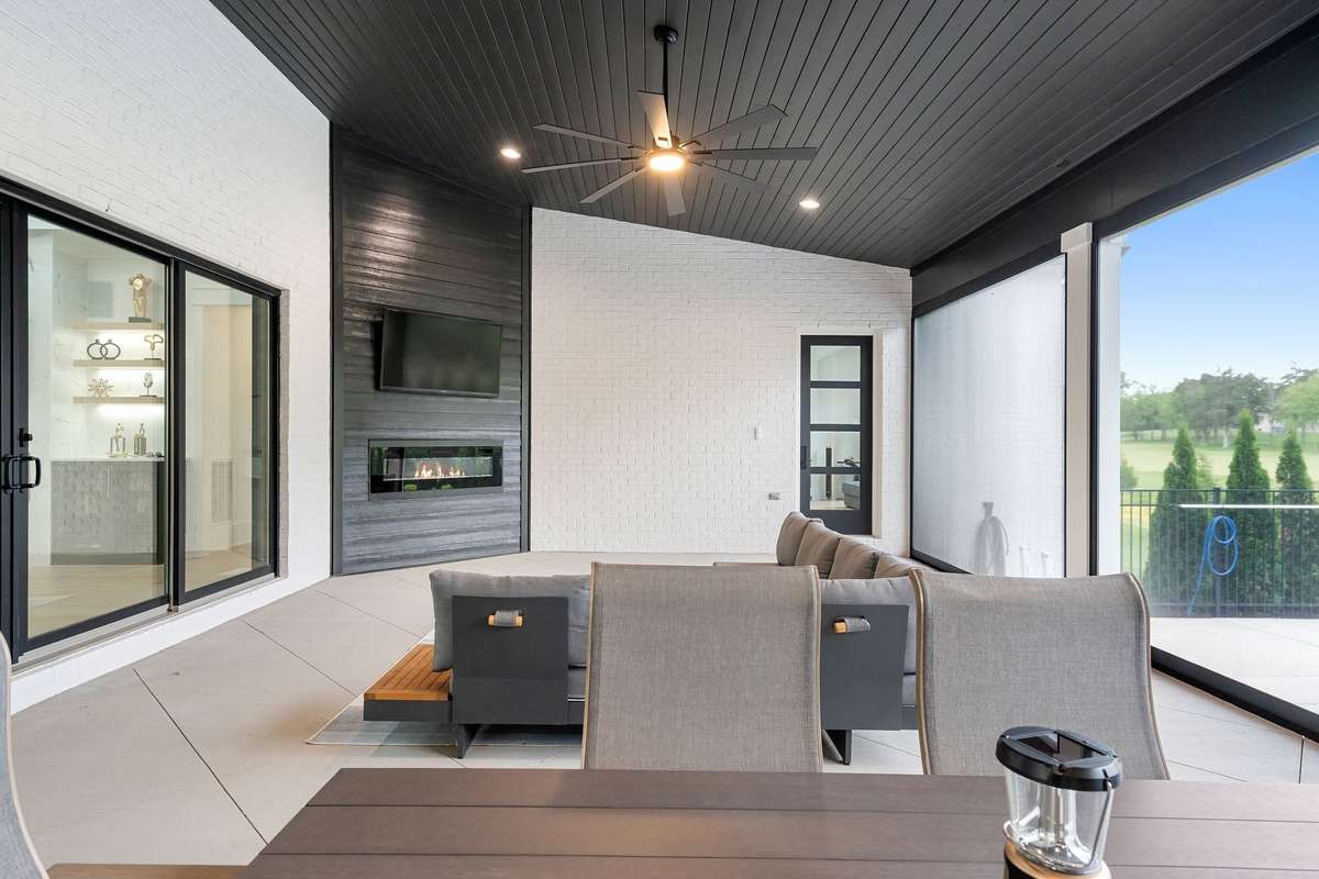 Covered outdoor patio with retractable screens for views of the backyard oasis.