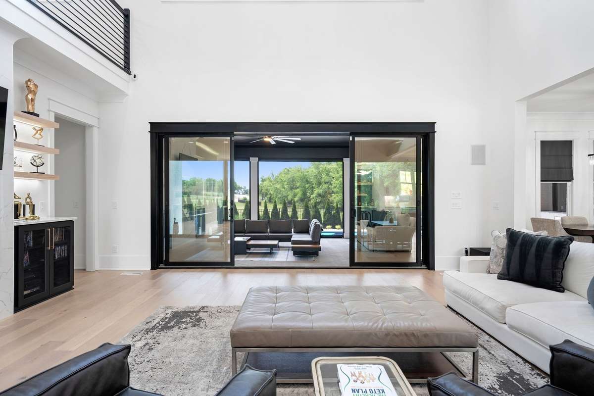 Wall of sliding glass doors creating seamless indoor-outdoor living and natural light.