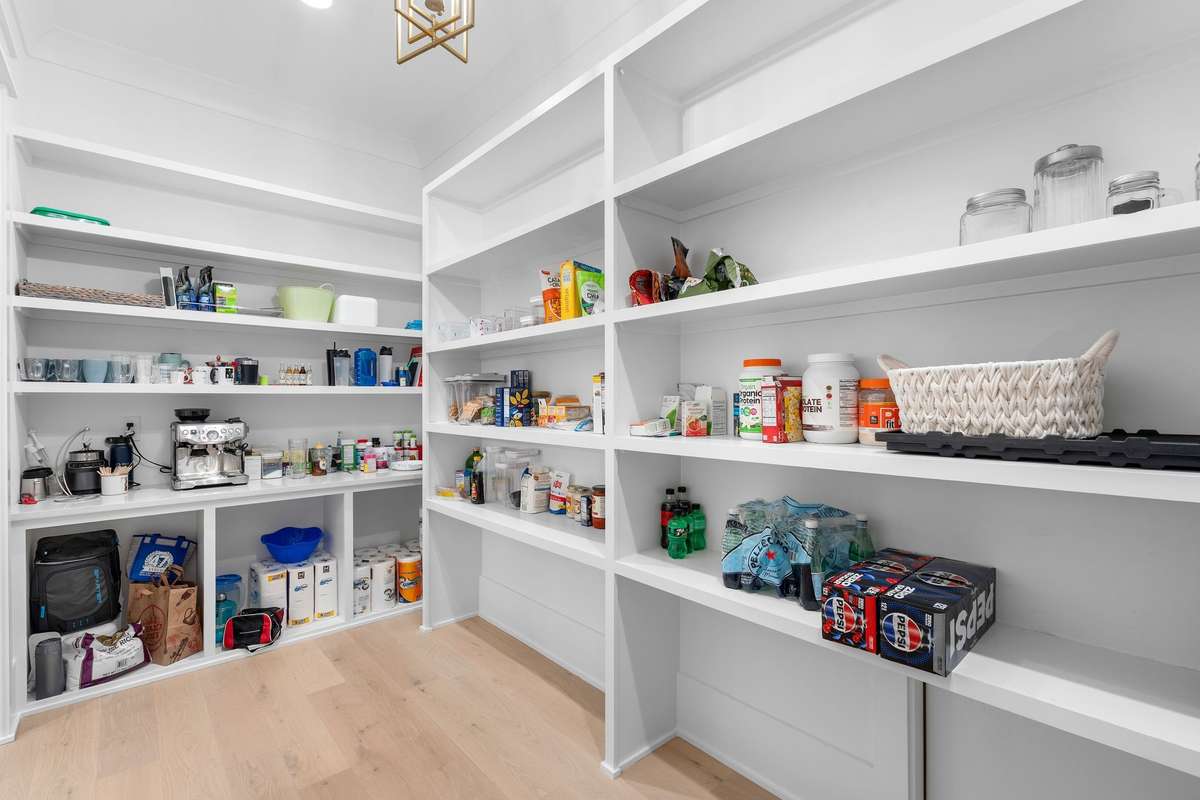 Fully customized pantry with abundant shelving to keep everything organized and within reach.