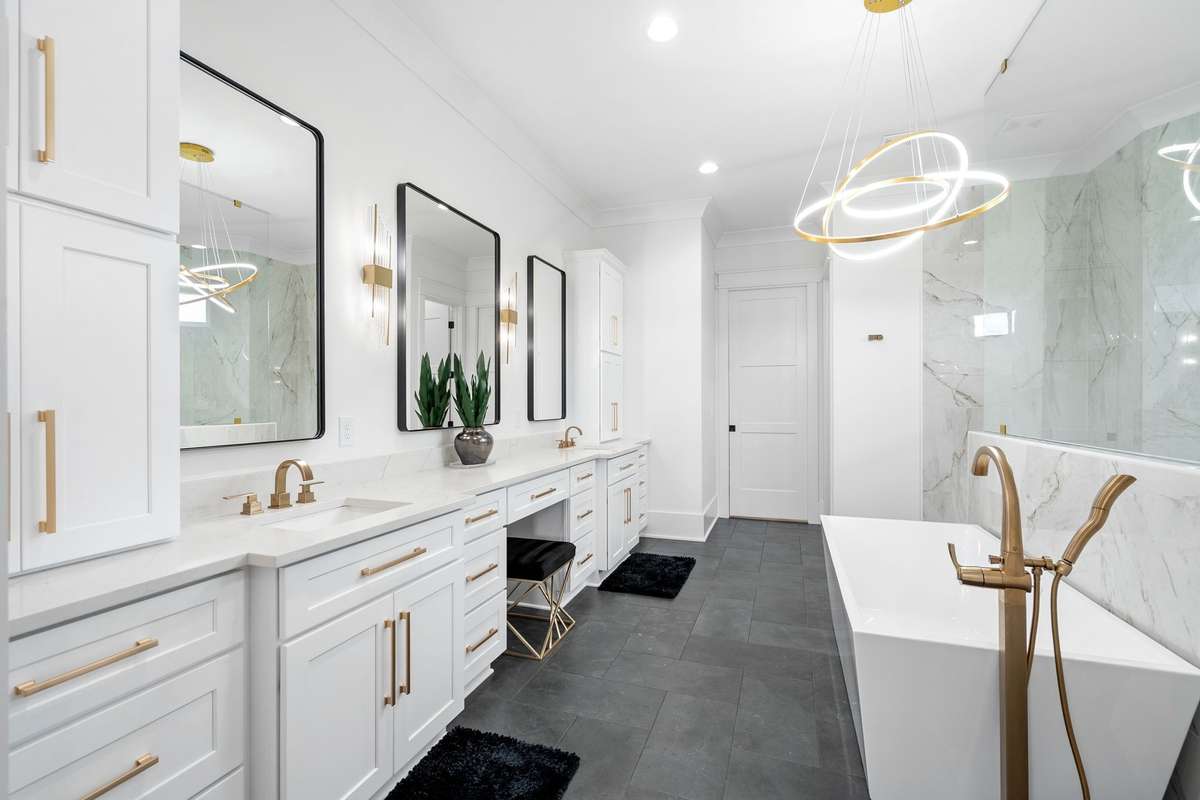 Spa-inspired bath with dual vanities, designer lighting, and premium finishes.