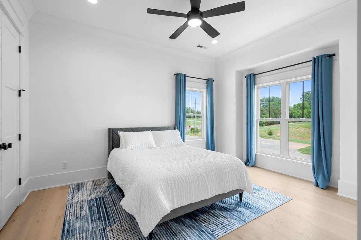 Bright and spacious Bedroom #4 offers large windows, designer finishes, and serene natural views.