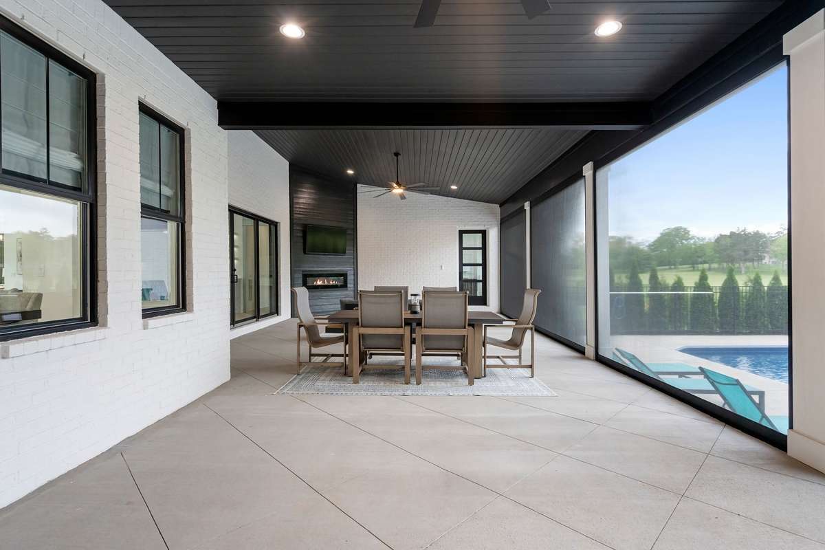 Outdoor dining space designed for entertaining with views of the backyard oasis.