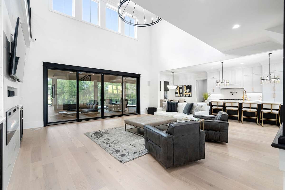 Impressive great room (22x20) with soaring 20’ ceilings, abundant natural light, and open-concept design.