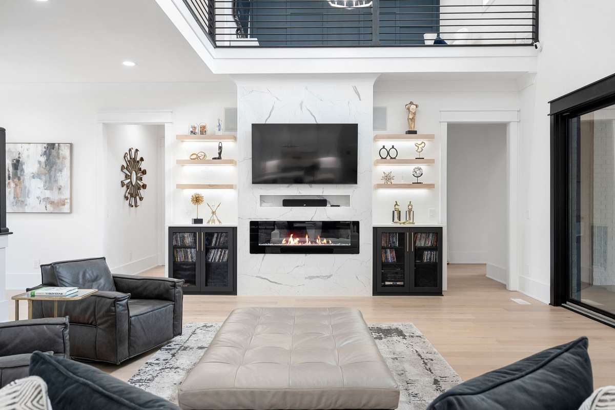 Custom fireplace wall with built-ins and sleek design—one of three fireplaces throughout the home.