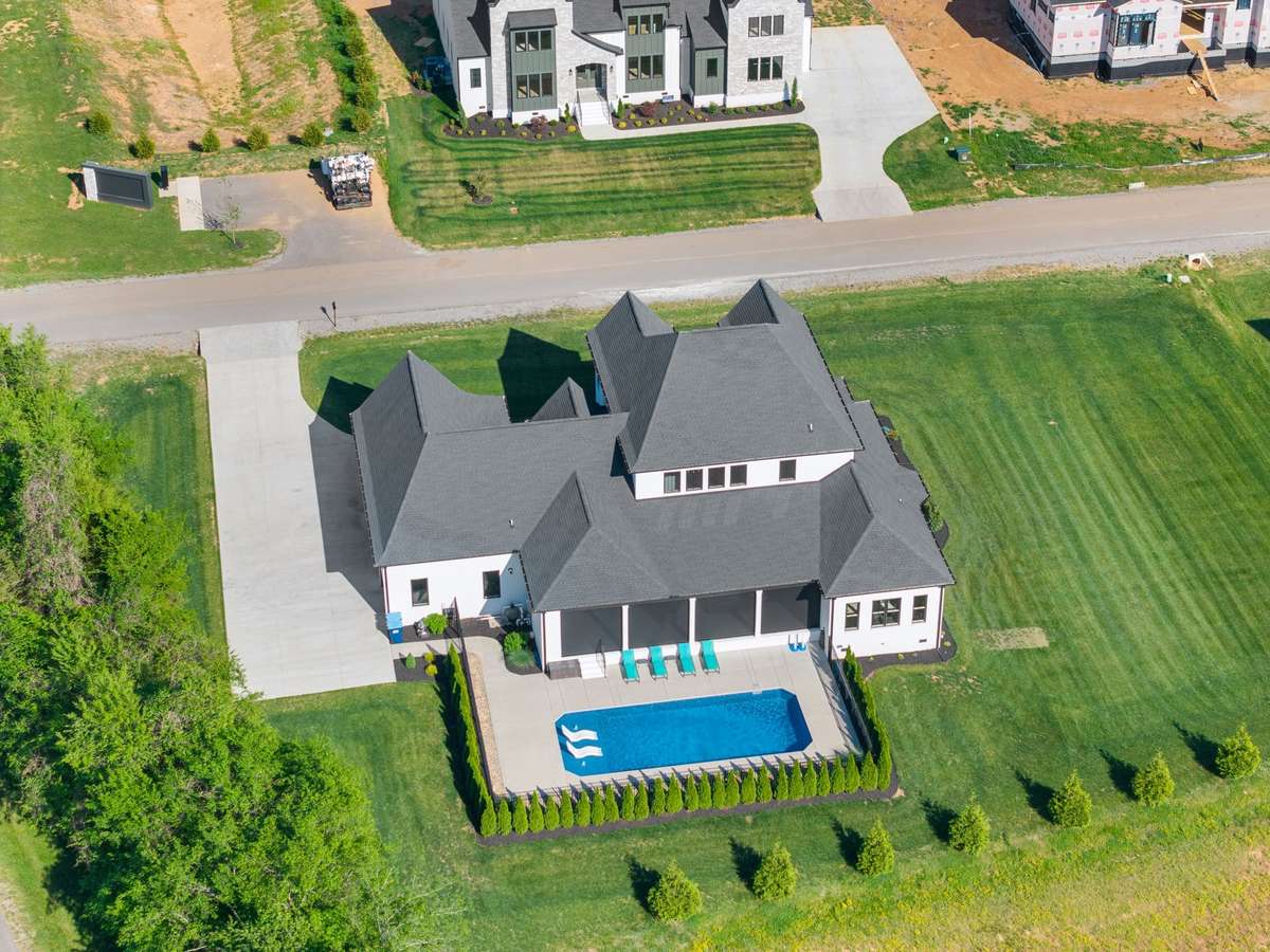 Backyard oasis featuring a 16’x40’ saltwater pool, tanning ledge, and expansive covered outdoor living area.