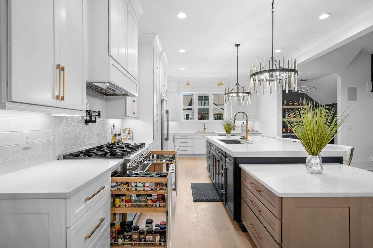 Gourmet kitchen showcasing custom cabinetry, oversized island, and designer lighting—perfectly blending style and function.