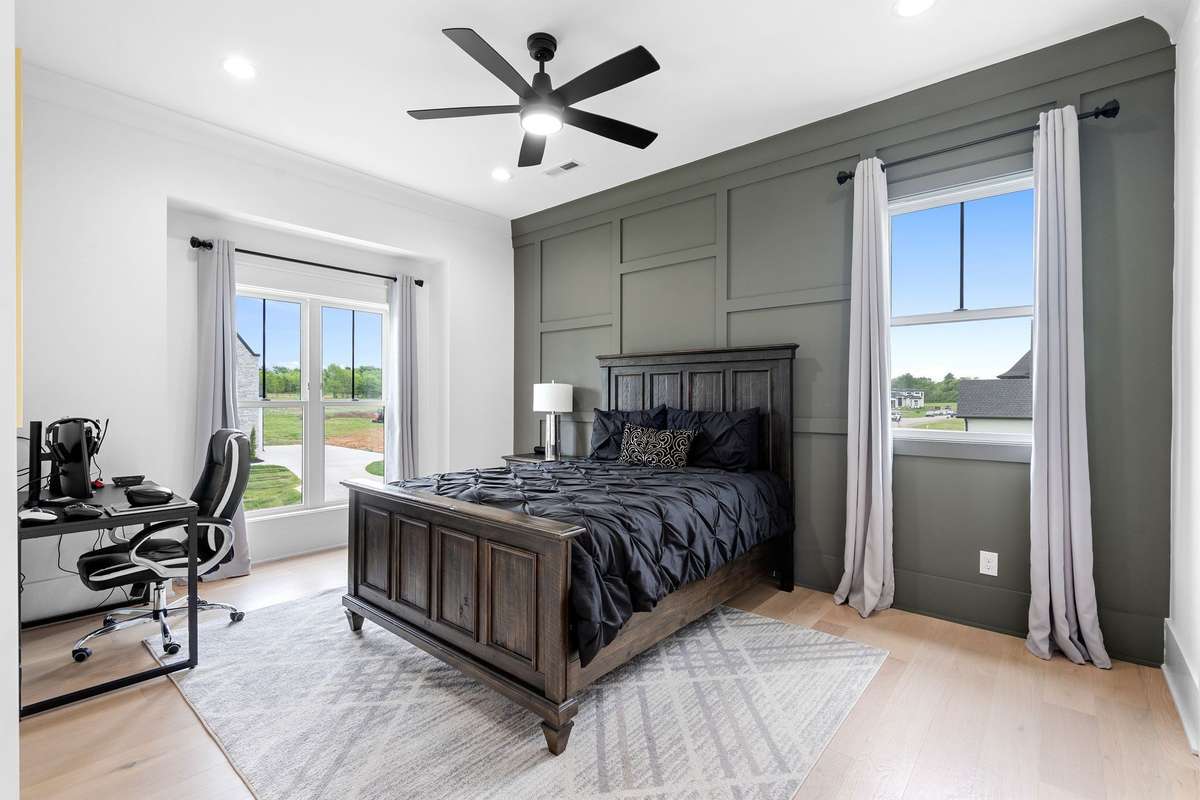 Generous Bedroom #3 is upstairs and features a designer accent wall, large windows, an ensuite bath and abundant natural light.