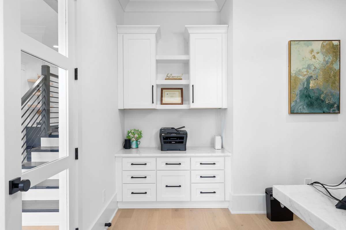 The home office space offers convenient workspace with custom cabinetry and storage, perfect for managing daily tasks from home.