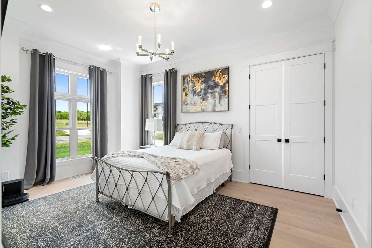 Spacious secondary bedroom on the main floor with natural light and designer finishes.