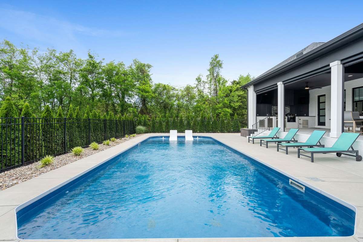 Wide, open patio surrounds the 16’x40’ pool—ideal for lounging, entertaining, and enjoying private backyard views.