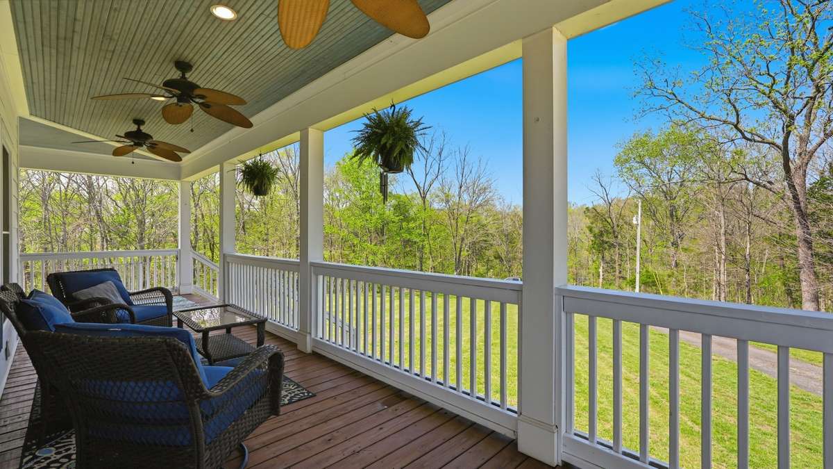 Imagine sipping your morning coffee and enjoying the peacefulness and privacy of this front porch.