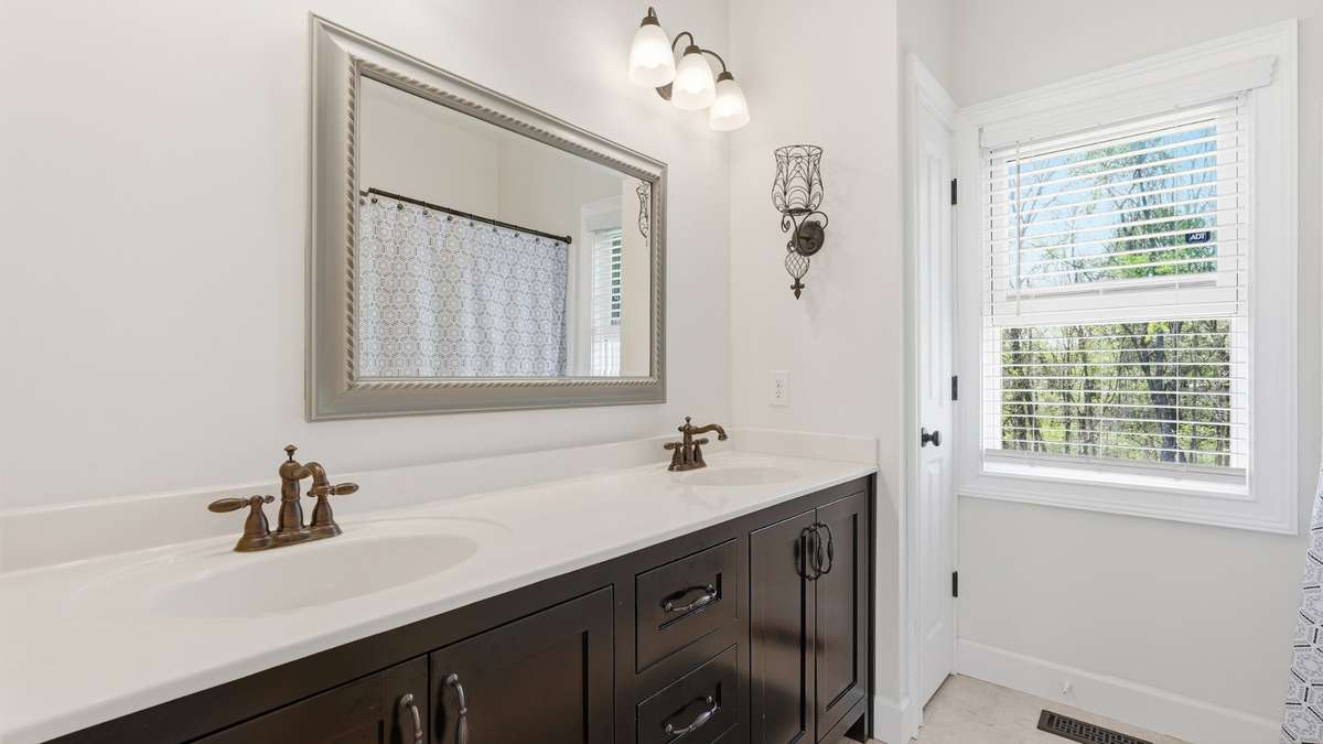 The primary bath features dual sinks and a tub/shower combo, plus linen closet!