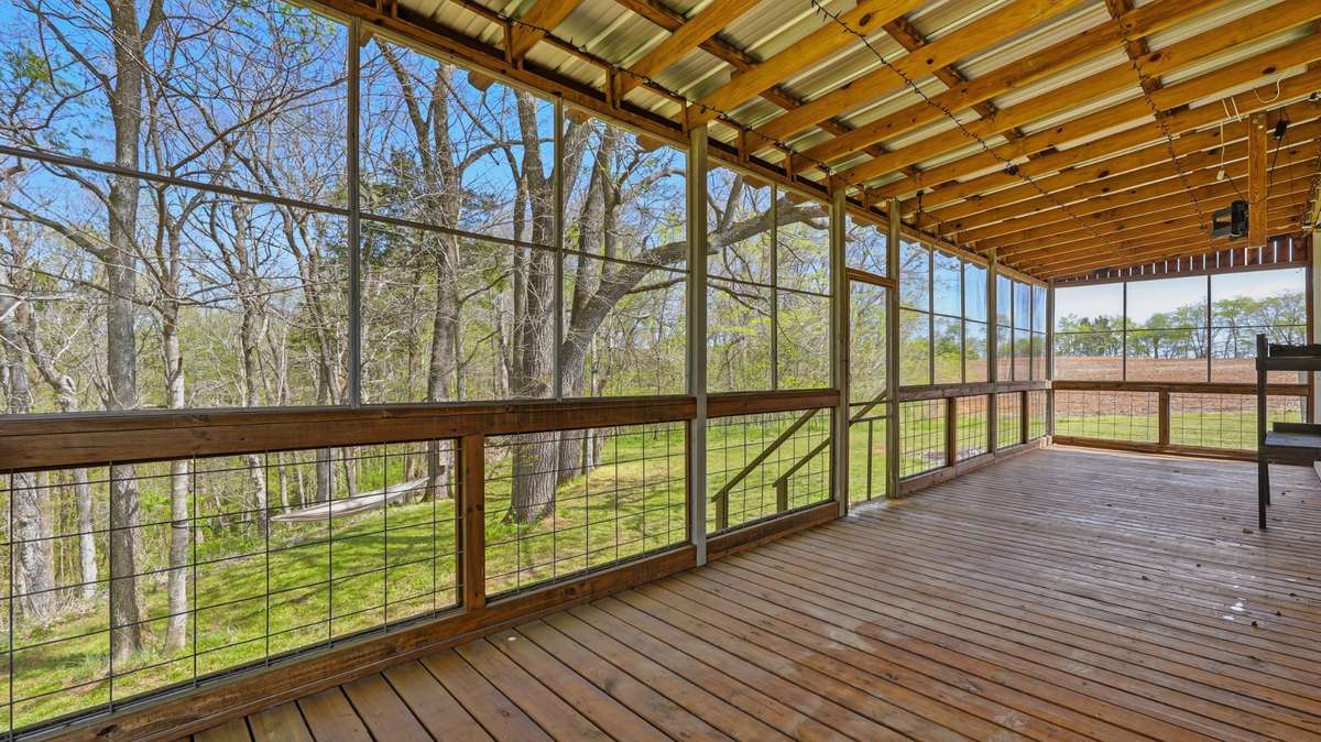Screened in porch off the garage offers serene space to relax in between projects.