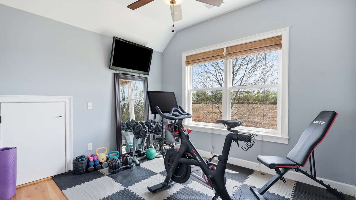 The 3rd bedroom is currently set up to be a home gym and offers attic access.