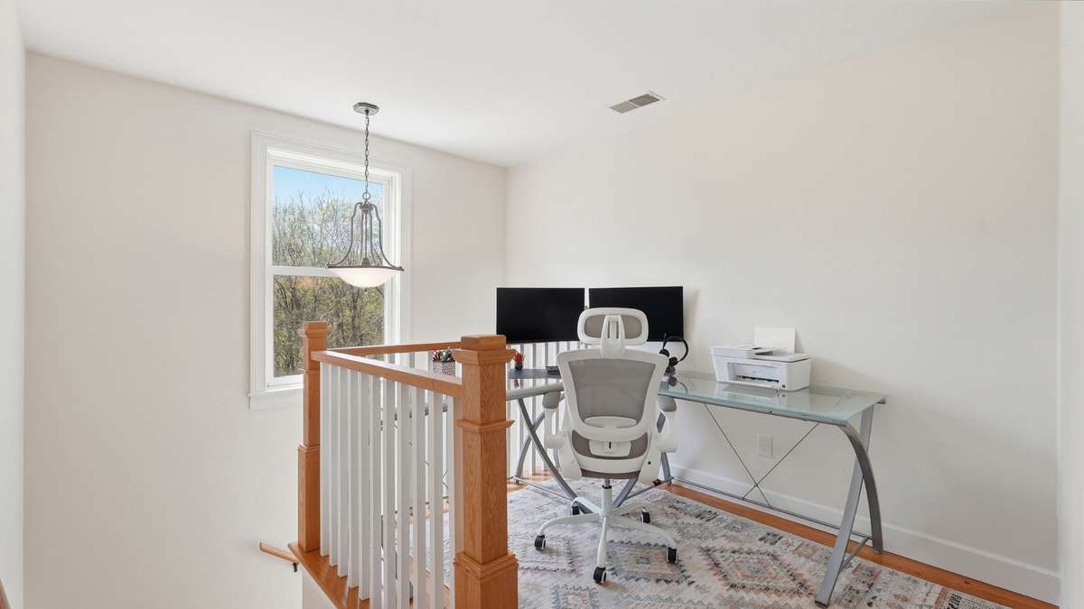 As you head upstairs, you’ll find a bonus nook at the top of the stairs. The sellers currently use this as a second home office.