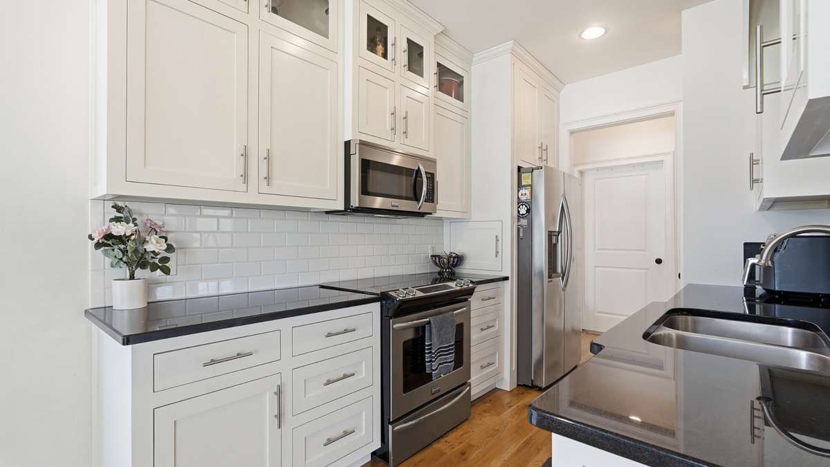 Kitchen features stainless steel appliances, an abundance of storage, plus a pantry!