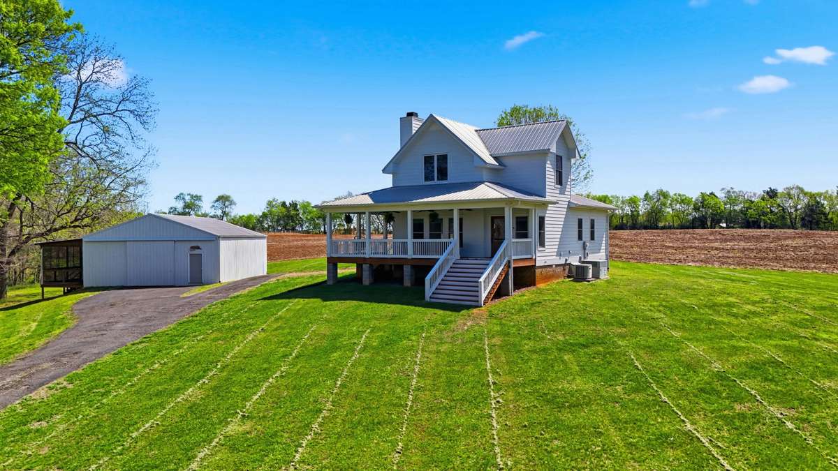 Main home features 3bed/2.5ba with a wrap around porch + a detached 30x40 workshop/garage with screened in porch.