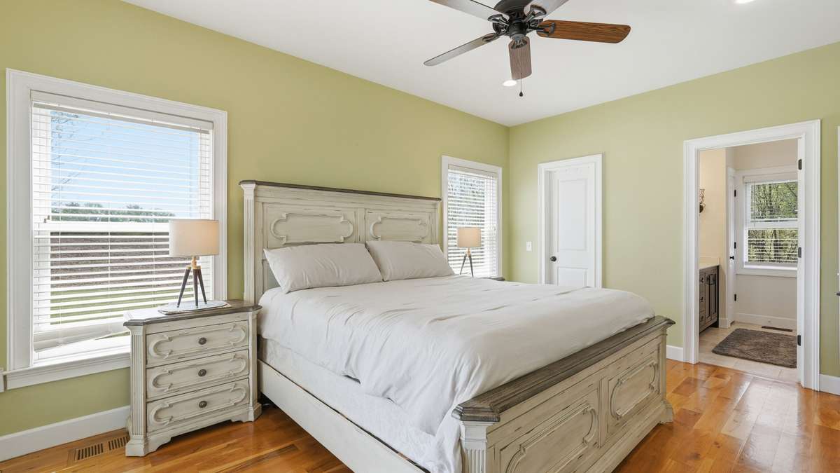As you continue past the kitchen, you’ll find an expansive primary bedroom on the first floor with ensuite bath.