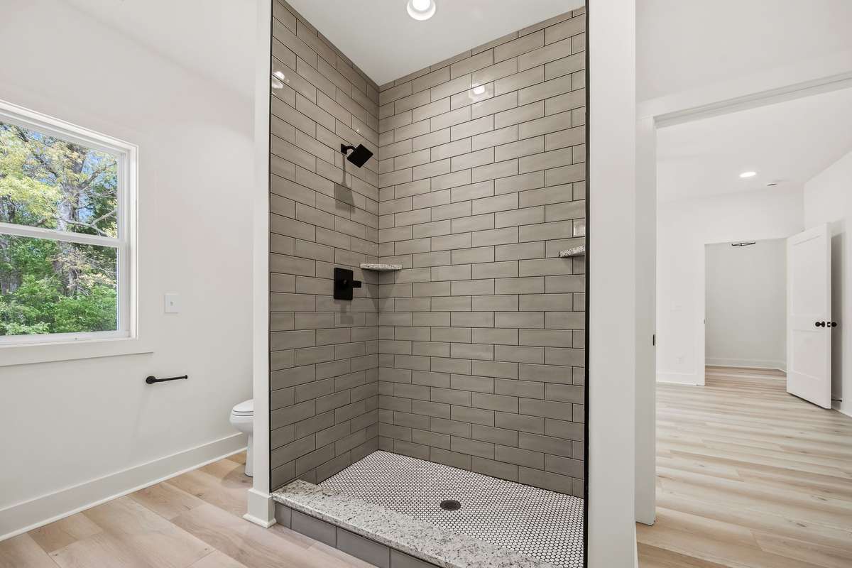Tile shower in primary bathroom