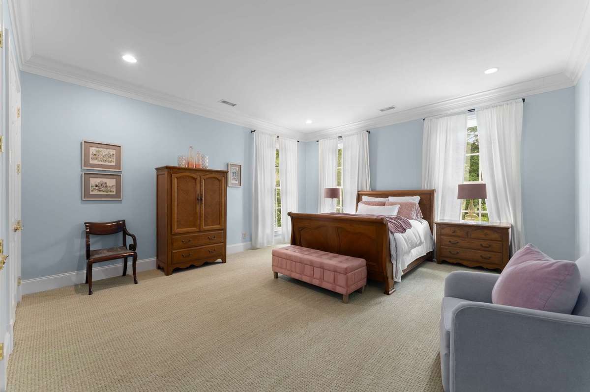 This pretty pink guest suite overlooks the back gardens and pool...