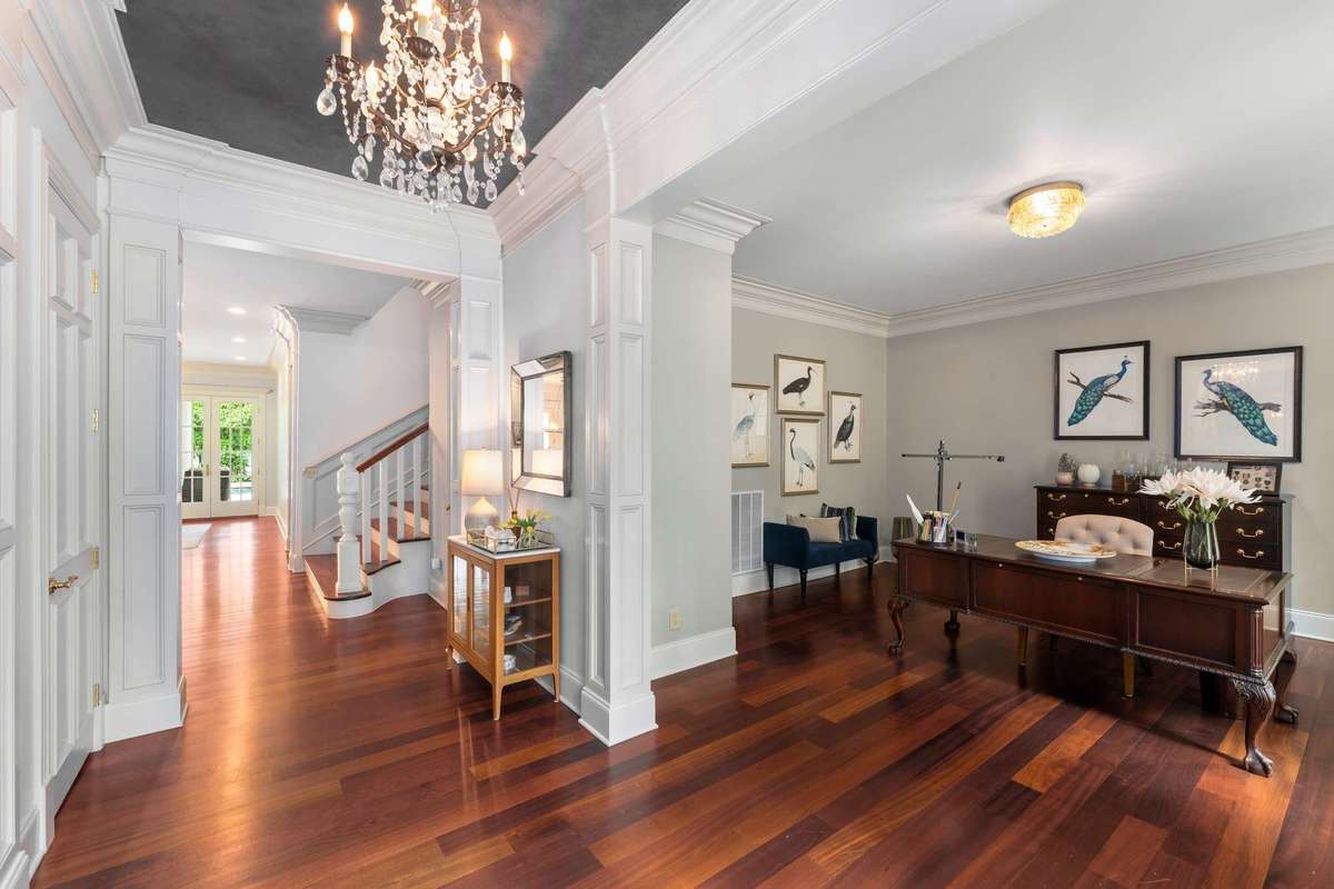 As you enter, notice the Brazilian Cherry flooring throughout the downstairs, the deep crown moulding and the 10 foot ceilings. Also, your office to your right...