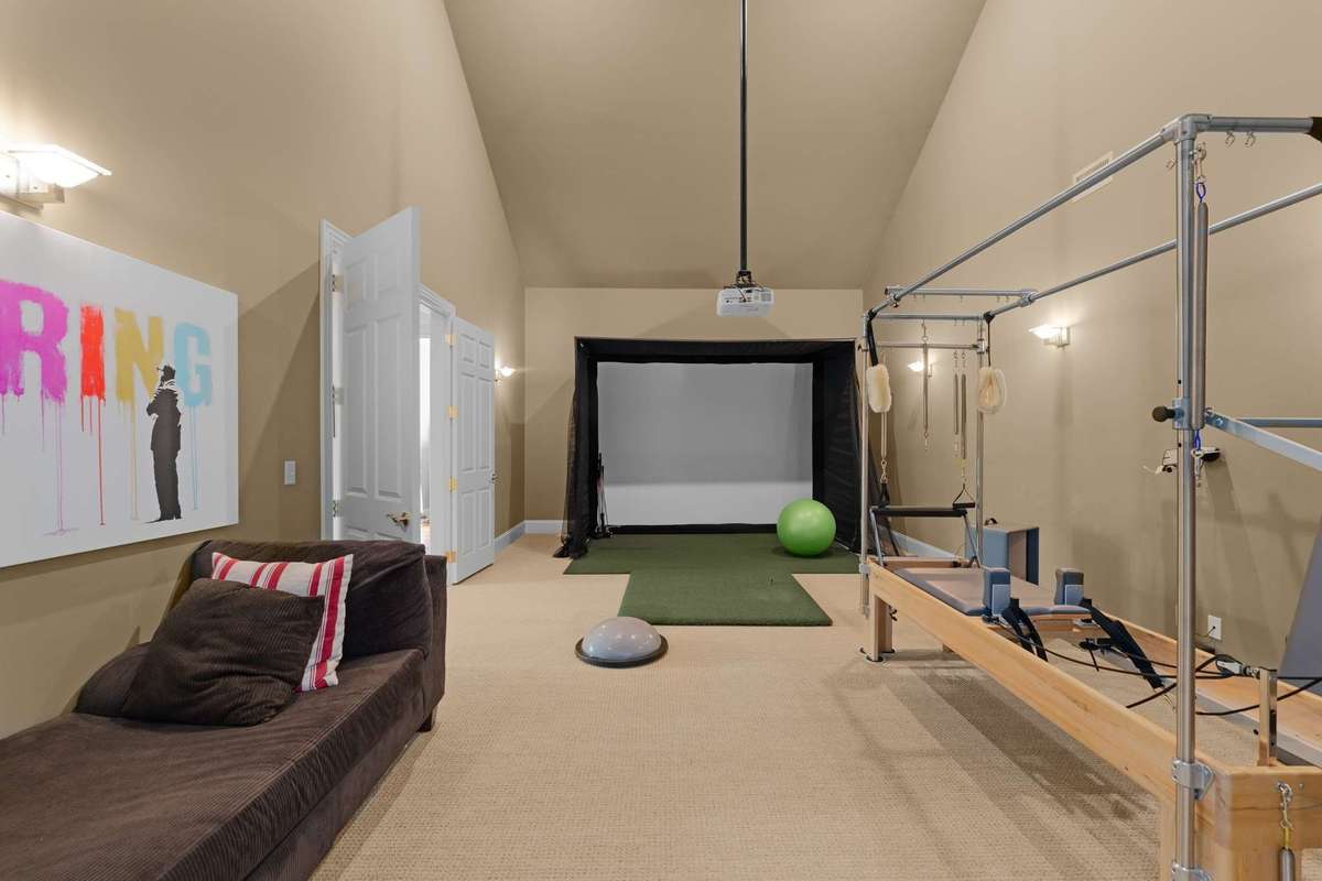 The upstairs recreation room currently hosts the golf simulater and the Pilates Reformer, but it also has equipment for your favorite movie...