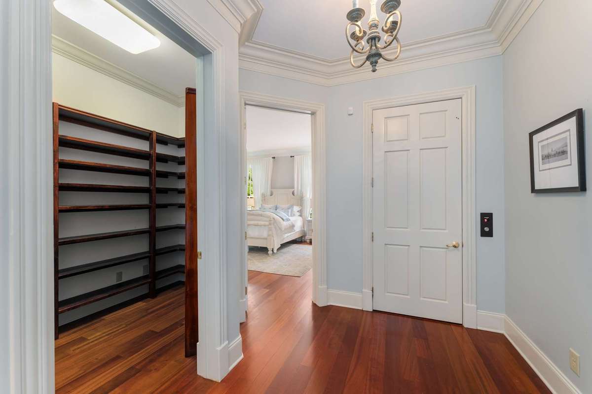 As you walk down the first floor hallway, passing the dining room, you will see the china closet on your left, the main floor guest suite straight ahead and the elevator straight on your right.  This accesses the second and third floors!