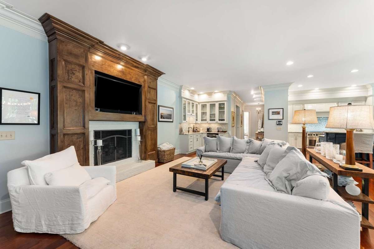 Another view of the space with this fireplace with solid wood stained surround....