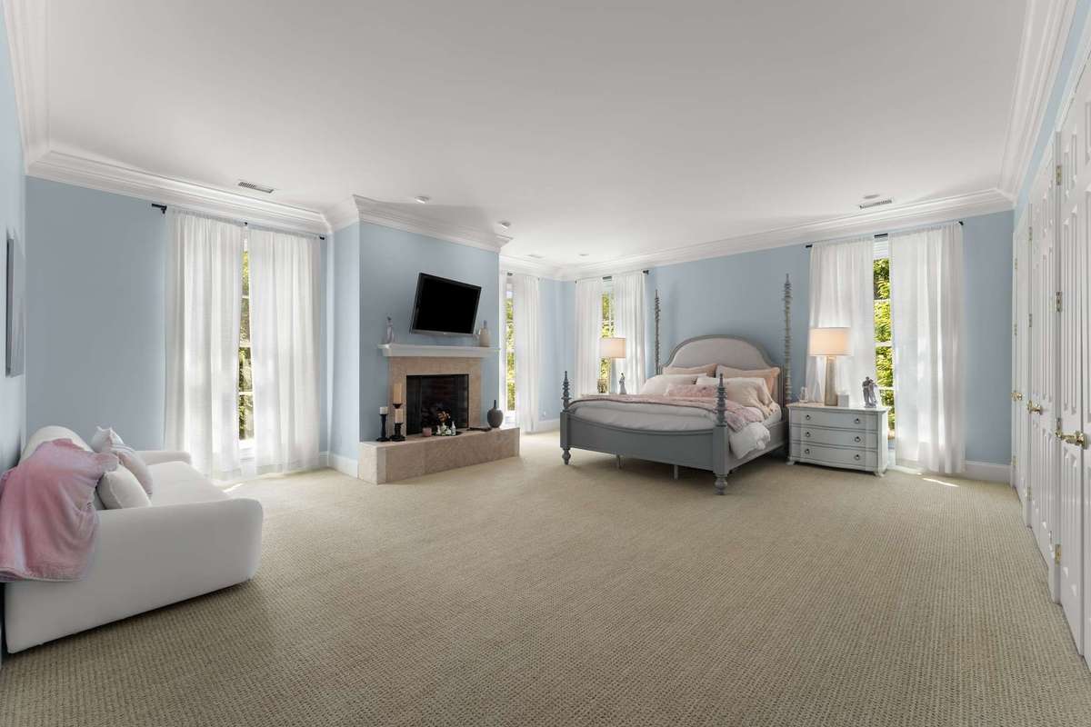 This second upstairs primary suite is incredible in its own right.  A fireplace for those cool nights, several of those floor to ceiling windows and a wall of closets...