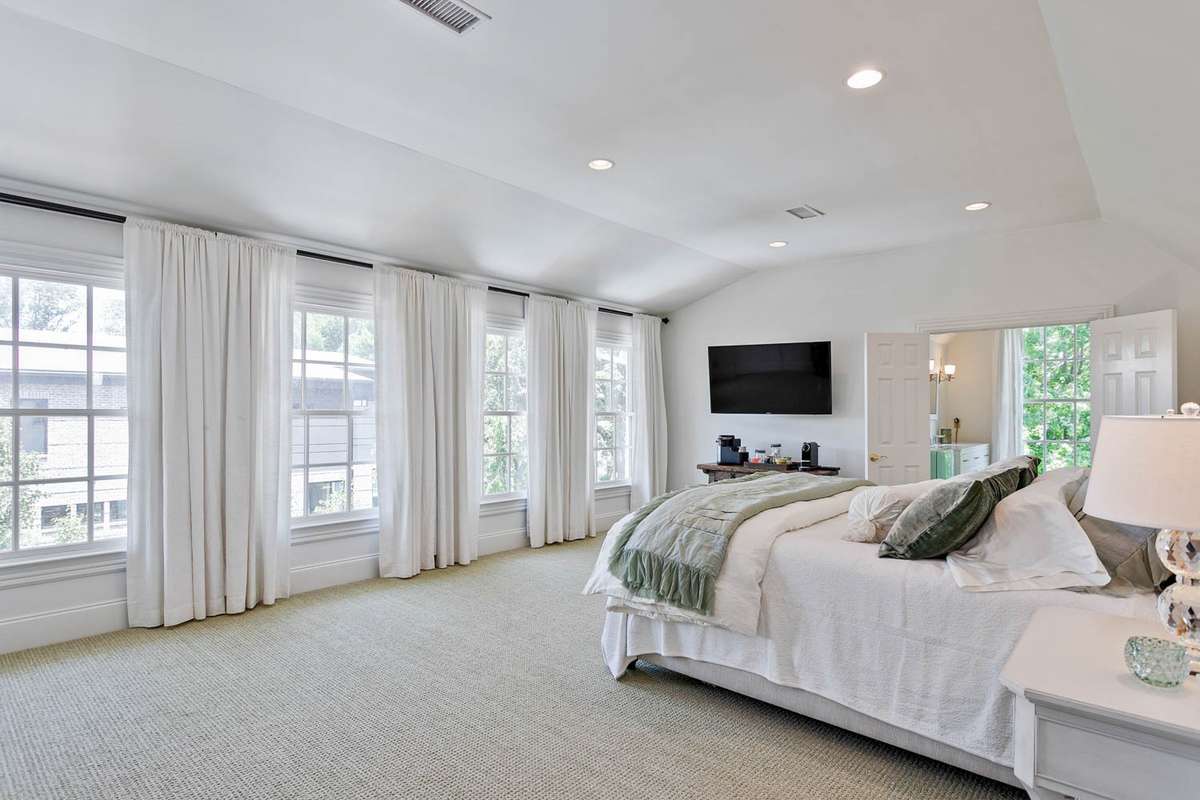 This upstairs ensuite is lined by this gorgeous wall of windows....