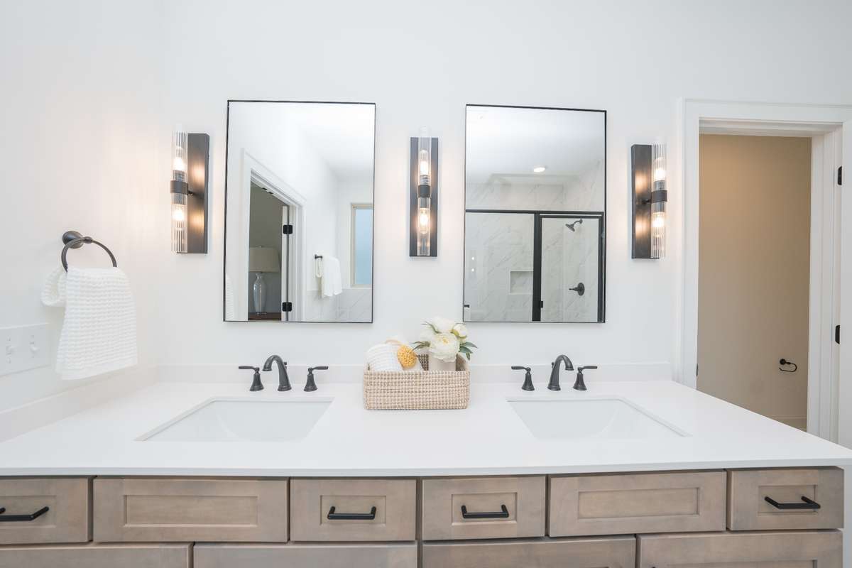 Double sinks with beautiful cabinetry and stylish matte black fixtures