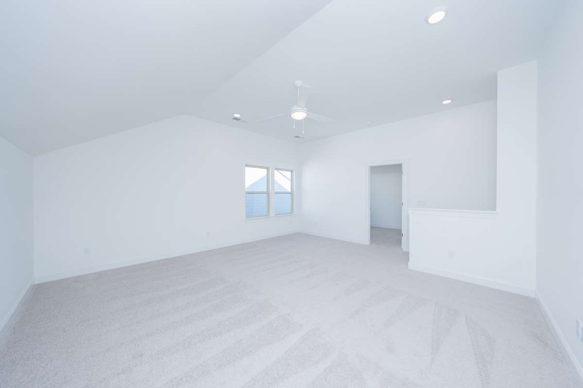 View of bonus looking toward stairs and door to private 5th bedroom/bath