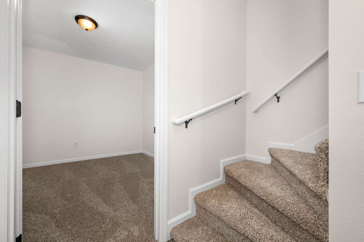 Stairs leading down to the basement living space.