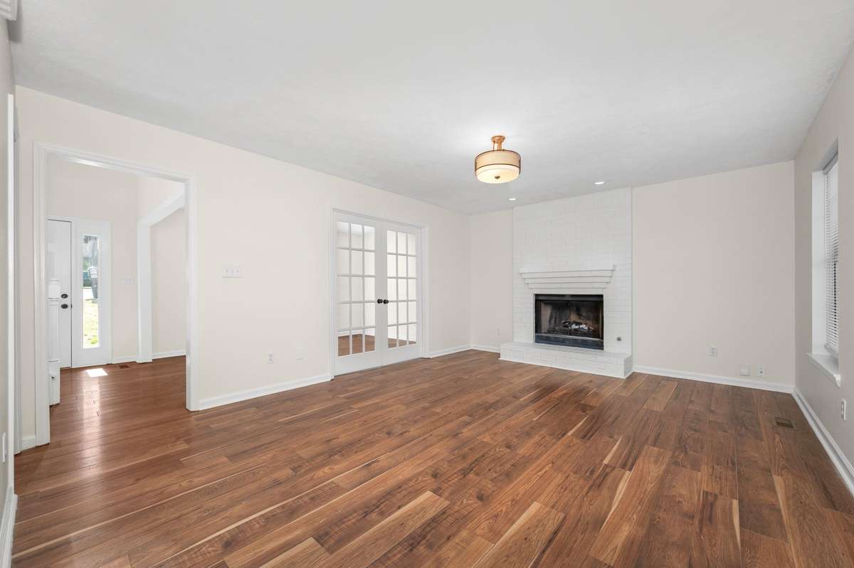 Den with fireplace looking toward the front entry.