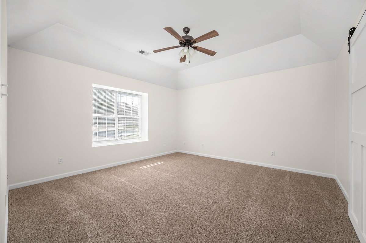 Upstairs primary with tray ceiling.