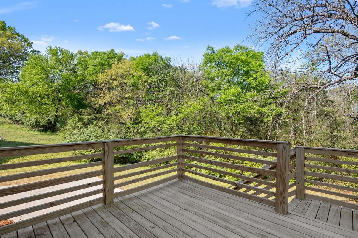 Relax on the back deck that overlooks the green space.