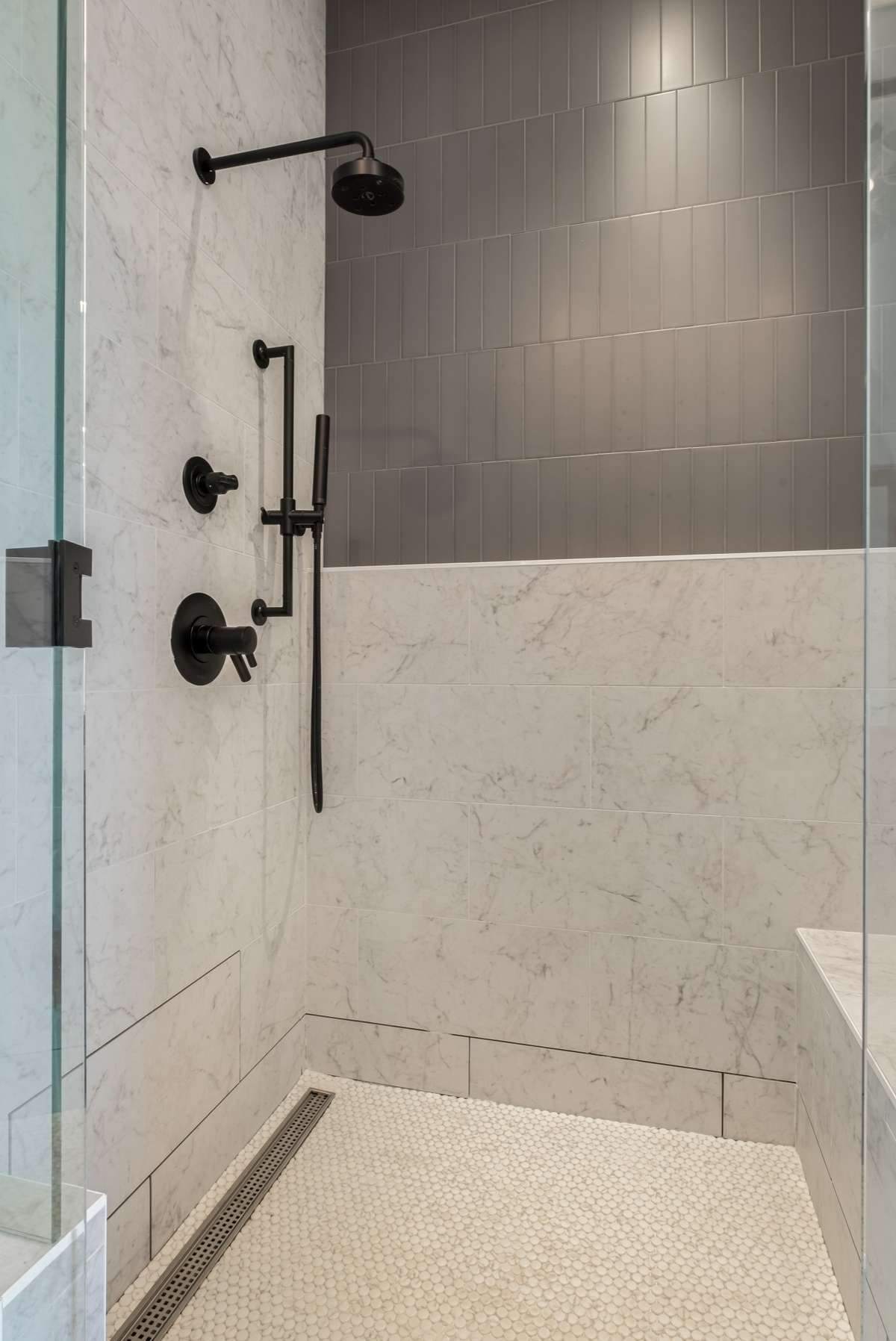 The spa-like shower features rich tilework and sleek, modern lines - a luxurious daily escape designed for both beauty and function