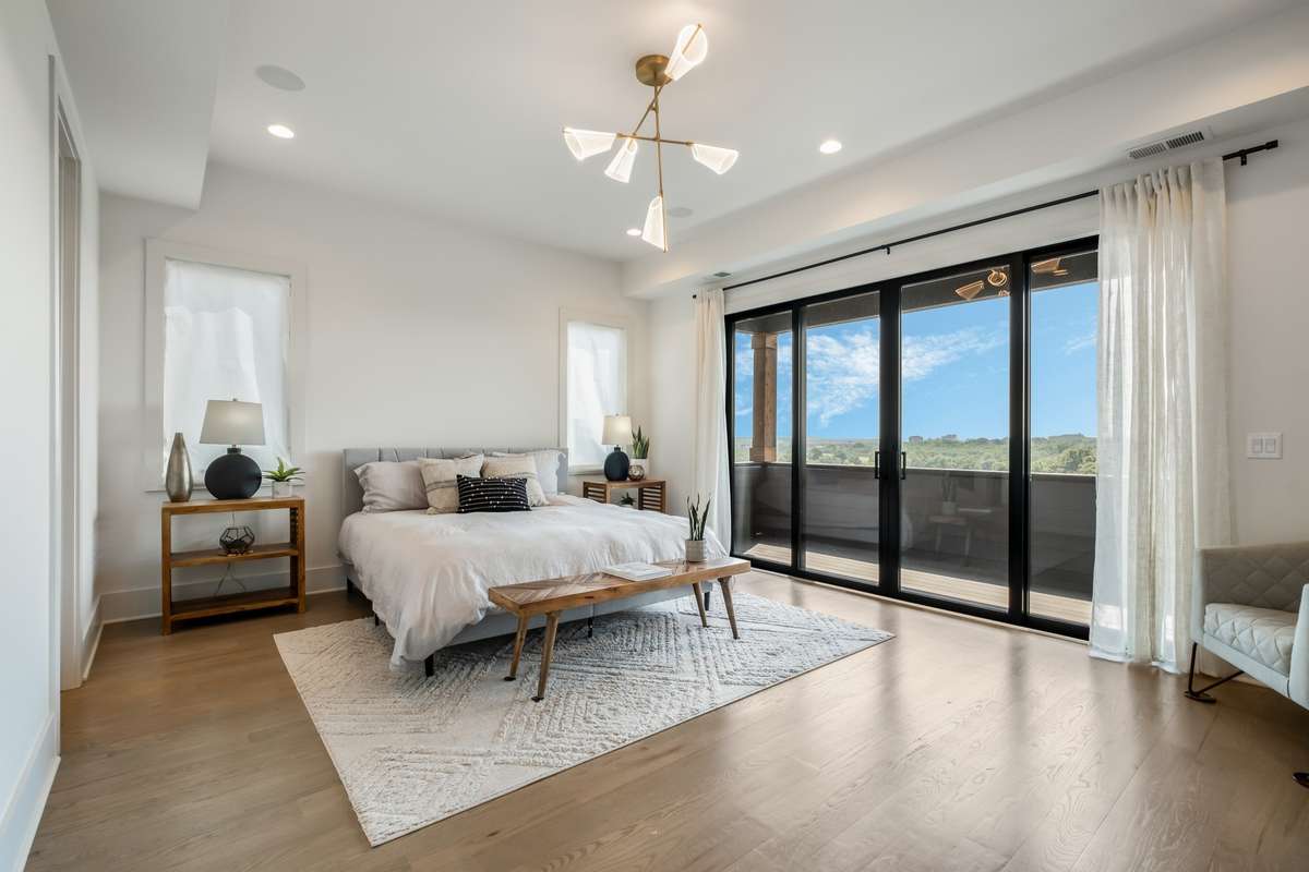 Wake up to skyline views - the owner’s suite features wall-to-wall windows and private balcony access for an elevated daily retreat.