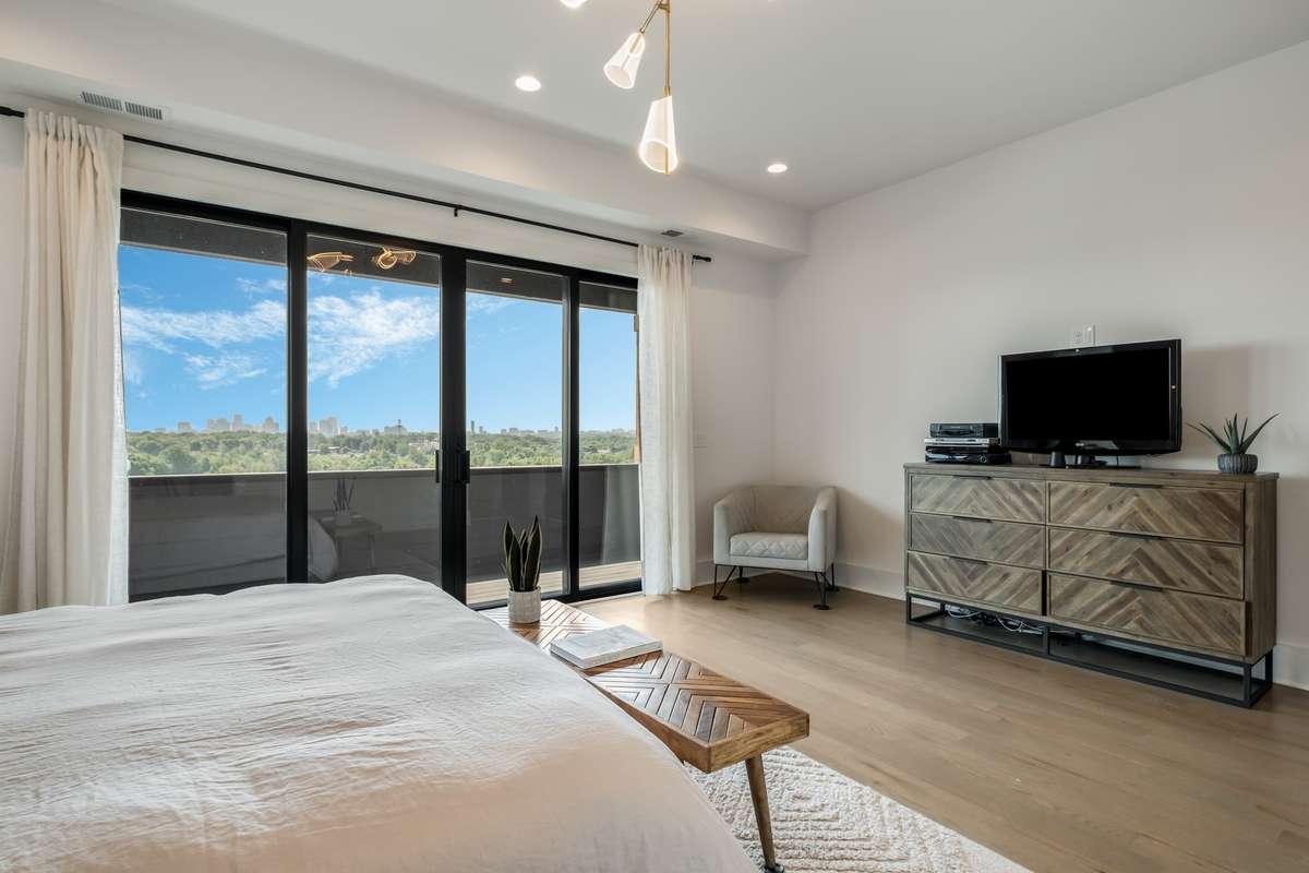 Spacious and serene, the primary bedroom offers warmth, privacy, and natural light from every corner.