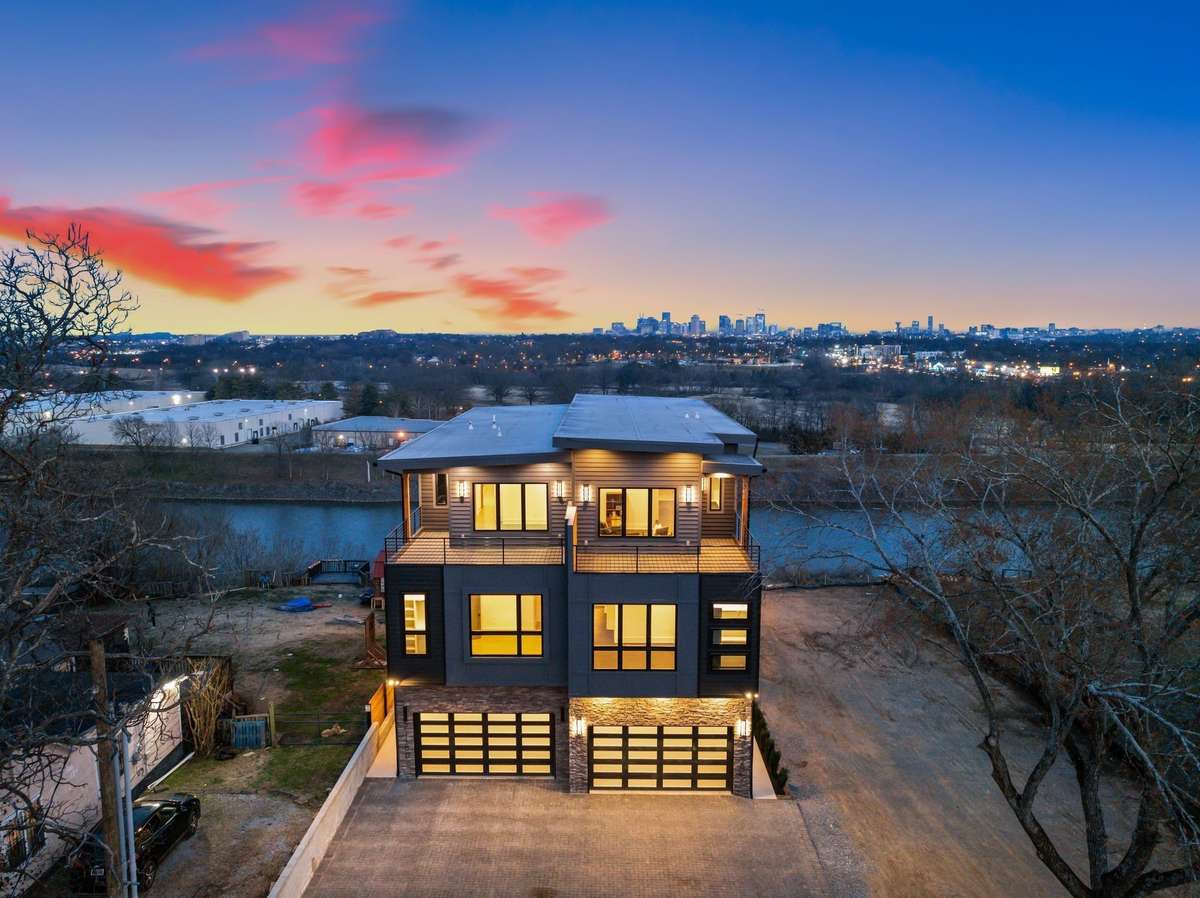 An architectural masterpiece set against a breathtaking sunset. Soak in the downtown skyline and river views from this elevated modern retreat.