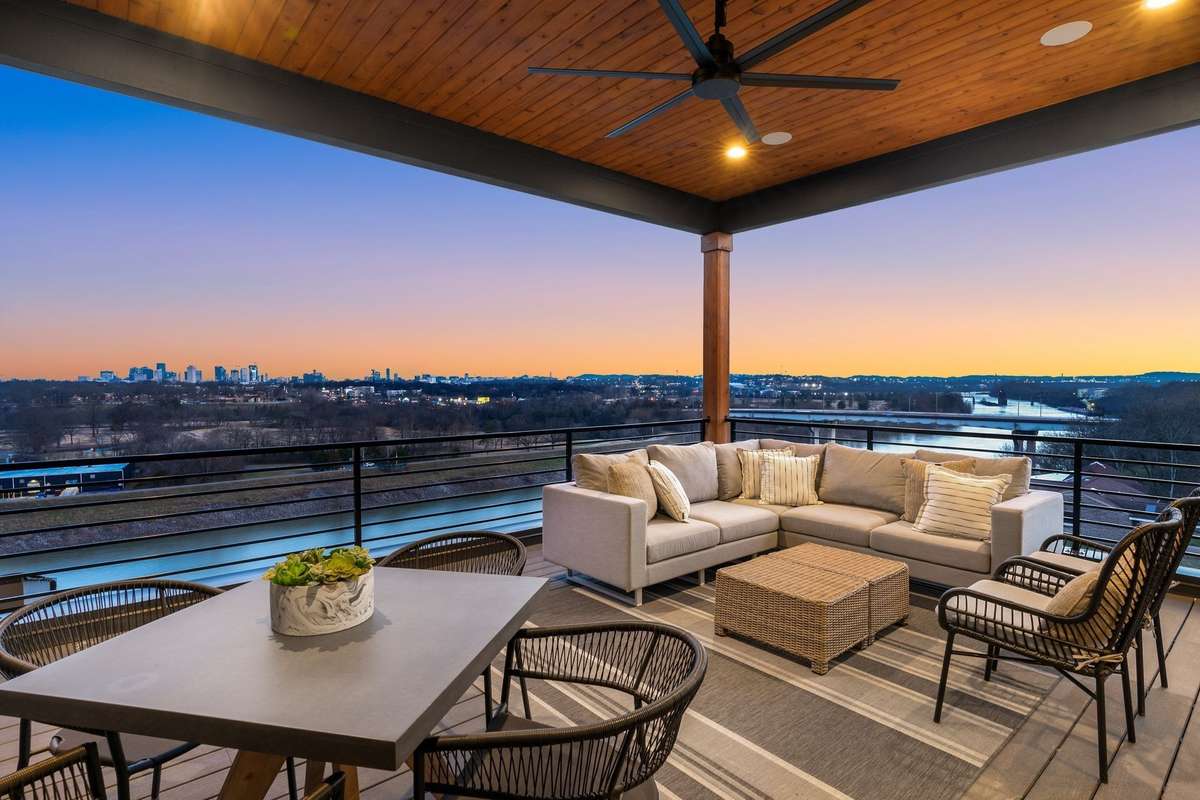From the covered balcony, enjoy panoramic views of the city, Cumberland River, and a glowing skyline -  all perfectly framed by golden hour.