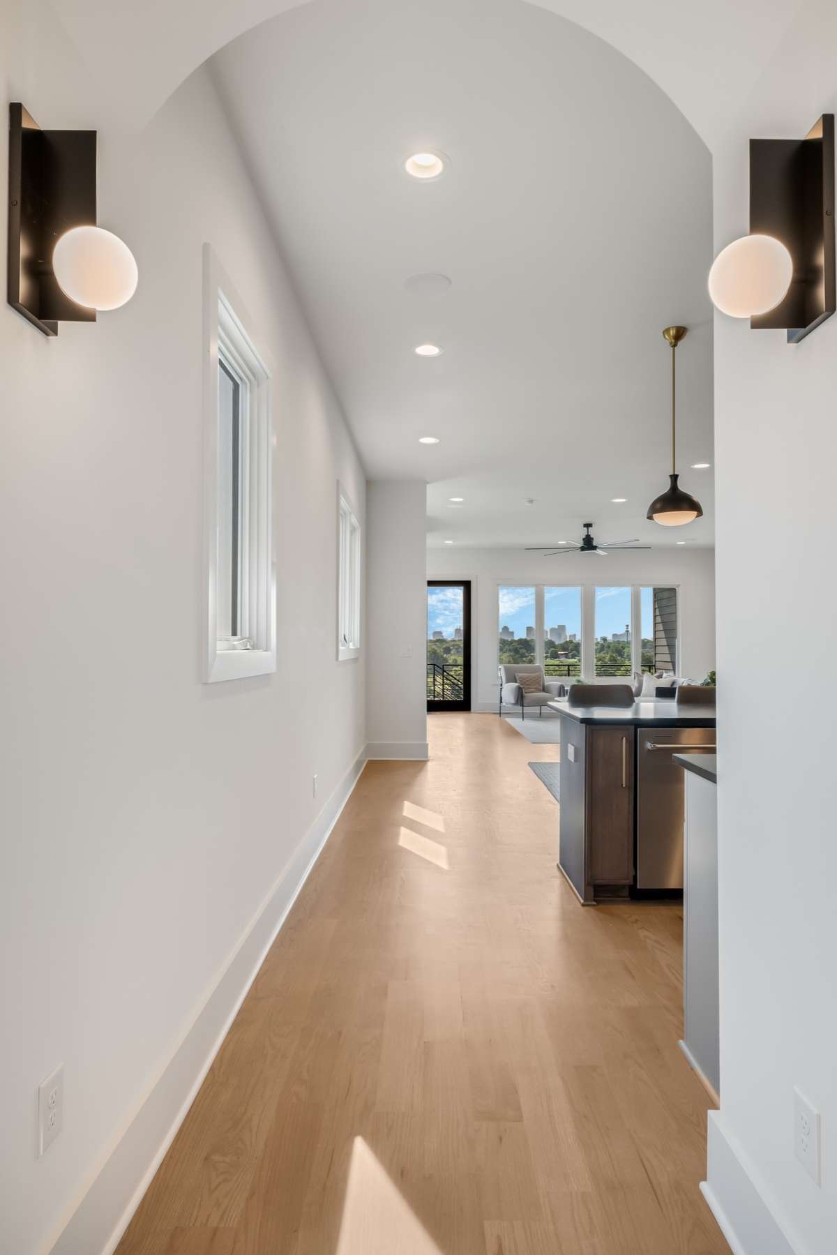 A stunning arched entryway welcomes you into the home -  and from the very first step, you’re greeted with uninterrupted views through expansive windows.