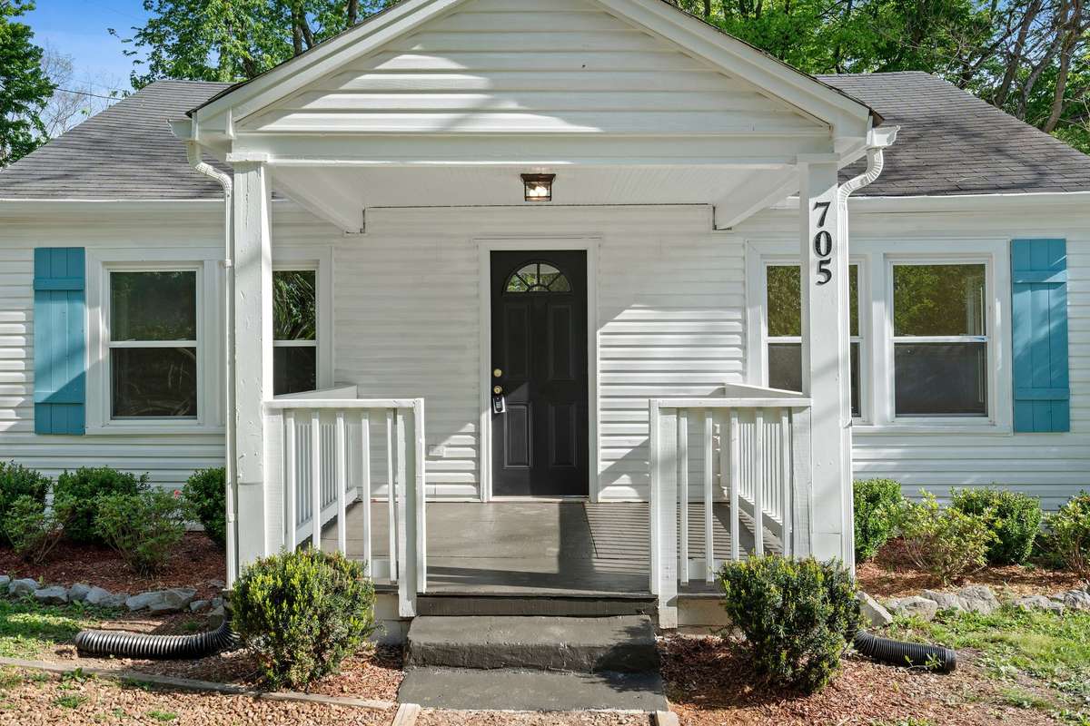 Welcoming front porch with classic white railing!