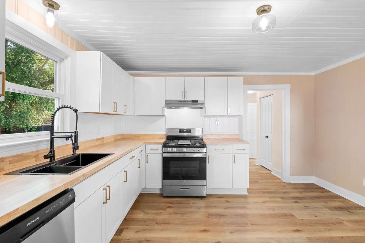 Clean white bead board backsplash adds a touch of classic charm!
